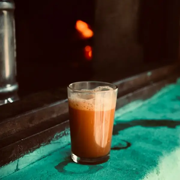 A glass of teh tarik on a kopitiam counter